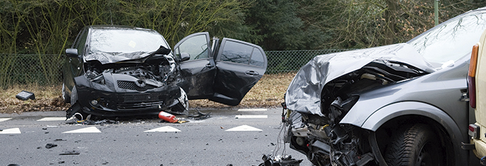 Two cars who crashed into another car on a interstate road